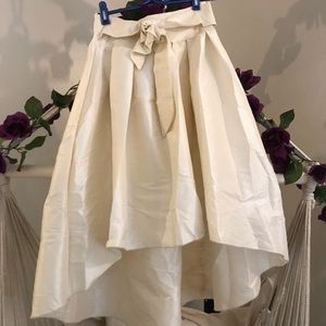 Pleated satin high low skirt with bow